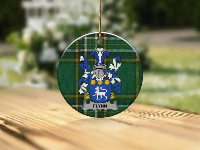 Flynn Irish Family Crest round Christmas ornament among festive lights