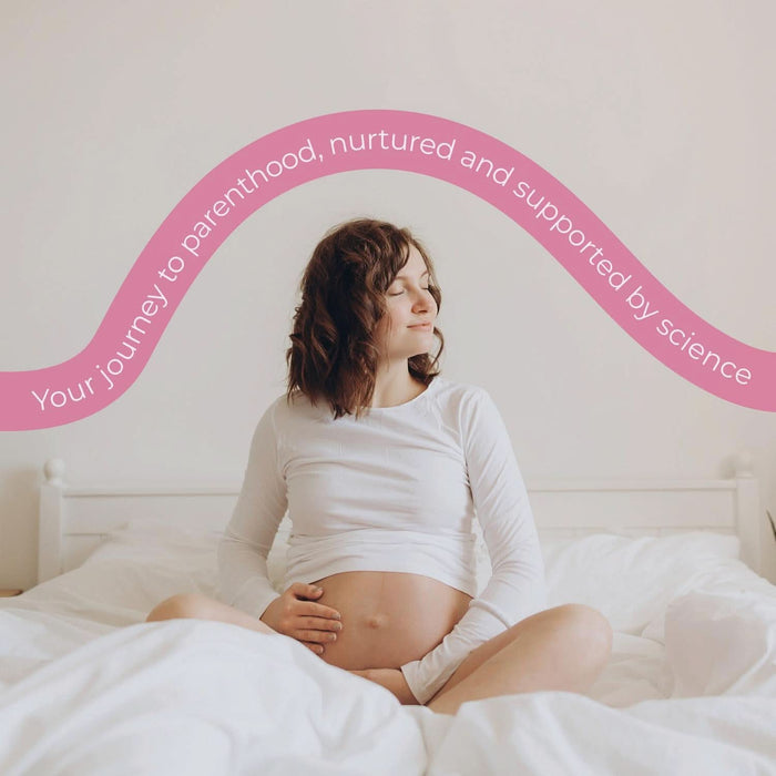 Pregnant woman sitting on white bed, cream background, pink wave reads "Your journey to parenthood, nurtured and supported by science" Health & Her Pregnancy
