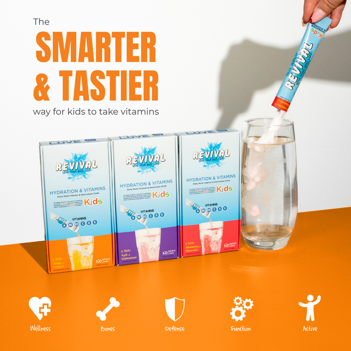 Revival Kids Vitamin Drink packs on orange surface, hand pouring Strawberry & Watermelon sachet into glass, white background.