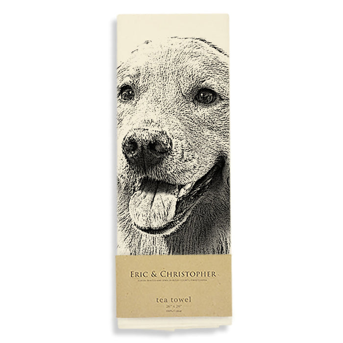 A packaged cream tea towel featuring the face of a golden retriever.