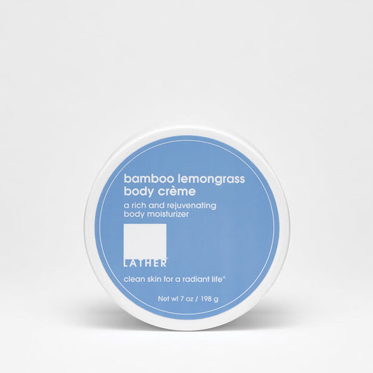 A container of Bamboo Lemongrass Body Crème by LATHER with a blue label on a white background.
