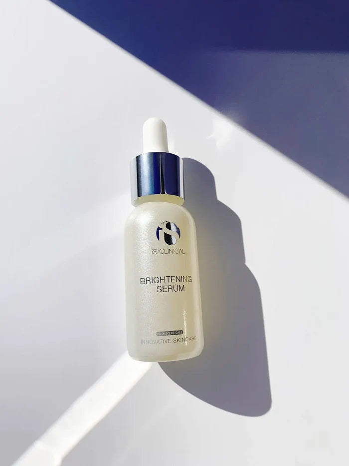 iS Clinical Brightening Serum in frosted glass bottle with silver dropper cap on white surface