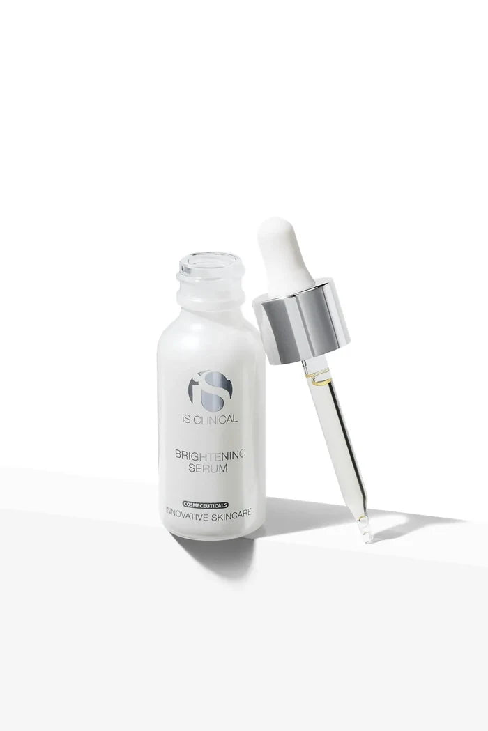 Open frosted glass bottle of iS Clinical Brightening Serum with silver and white dropper beside it on white background