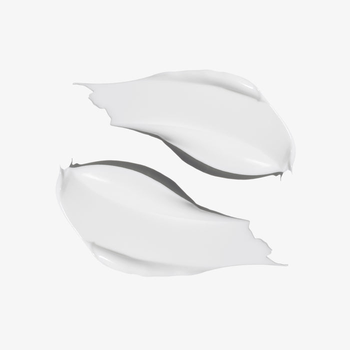 Two smooth, glossy white cream swatches with soft gray shadows on a clean white background.