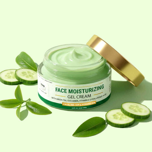 Jar of face moisturizing gel cream with cucumber slices and leaves on a light green background