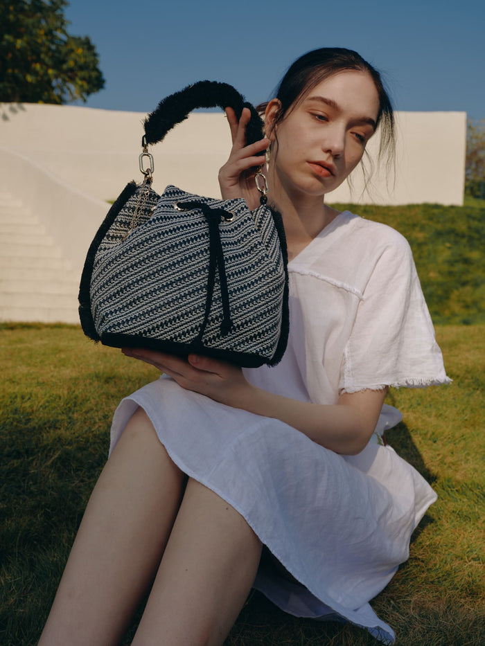 Fringed woven bucket bag with chevron texture and drawstring detail wholesale
