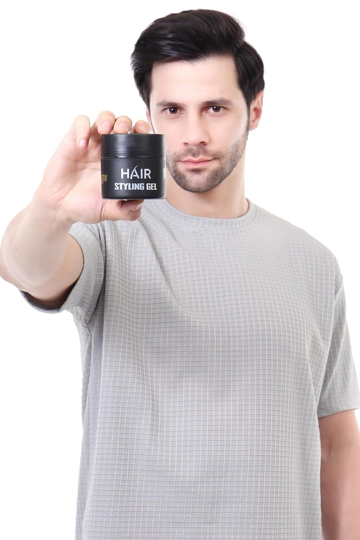 hair styling gel in black bottle holding by a man