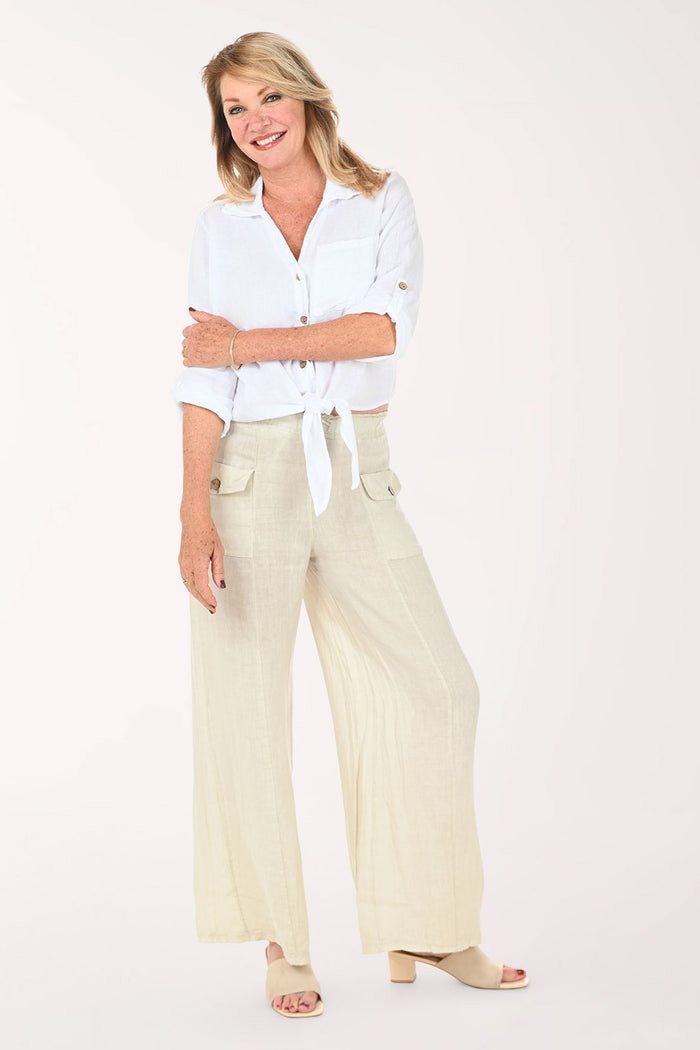 Woman wearing a white button down top and beige pants