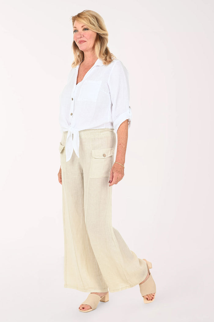 Woman wearing a white button down top and beige pants