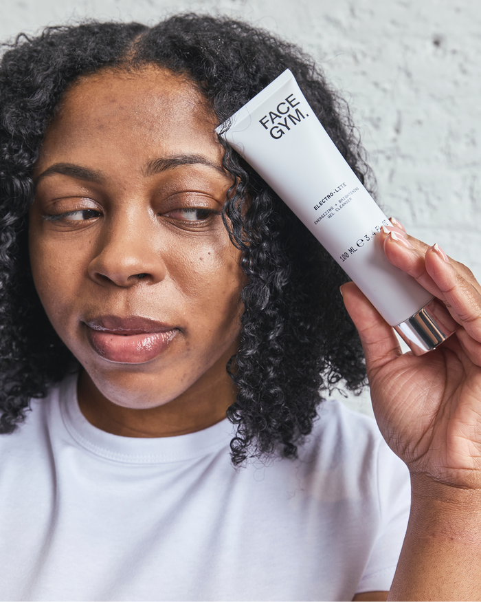 a woman holding a white tube