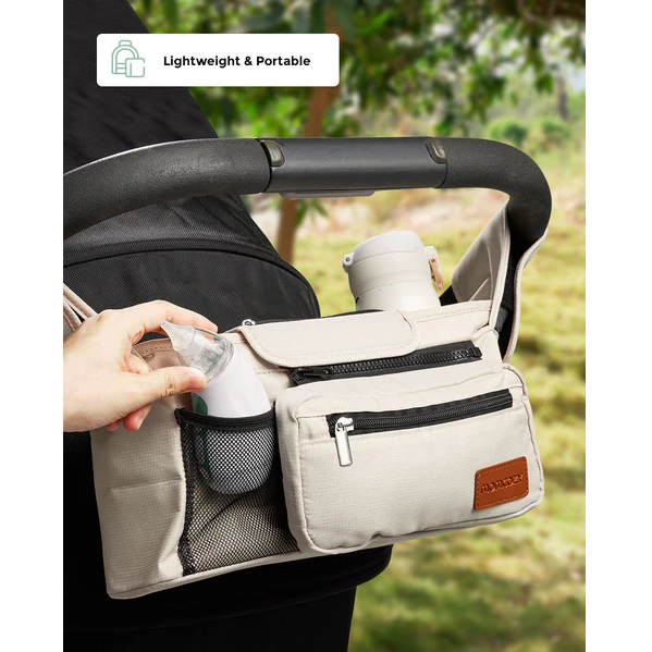 Momcozy Nasal Aspirator stored in a beige stroller organizer bag, hand reaching in, text reads "Lightweight & Portable"