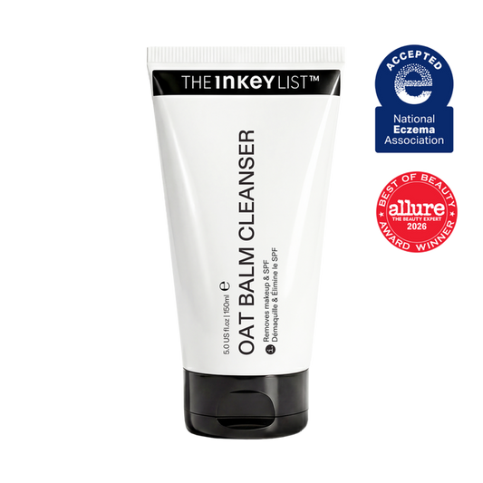 A white tube of The Inkey List Oat Balm Cleanser with a black cap, shown on a plain white background alongside two award badges: a blue National Eczema Association 'Accepted' badge and a red Allure 'Best of Beauty 2026' award badge.