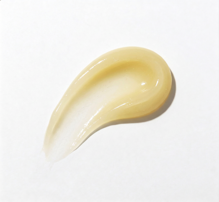 Beige cream droplet on a white background
