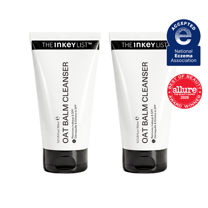 Two white tubes of OAT BALM CLEANSER by THE INKEY LIST with black caps, shown side by side on a white background with a blue and red award badge on the right.