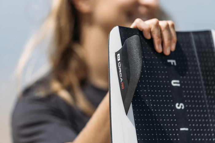 ORCA Pro x CORE fins mounted on twin-tip kiteboard heel-side