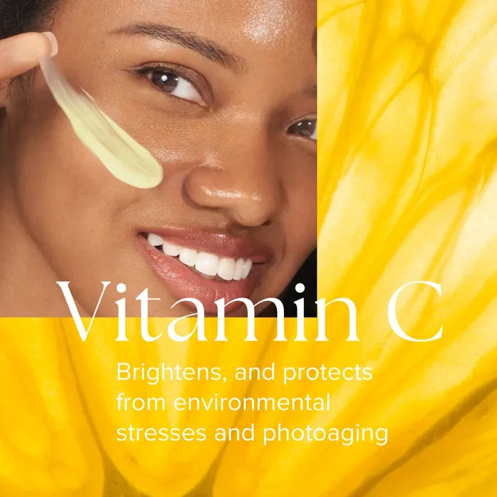 Close-up of smiling woman applying pale yellow emulsion to cheek with text about Vitamin C benefits