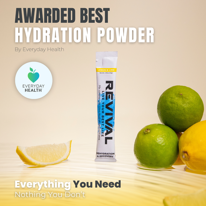 Revival Rehydration & Recovery Lemon & Lime electrolyte drink sachet with limes and lemon on cream background