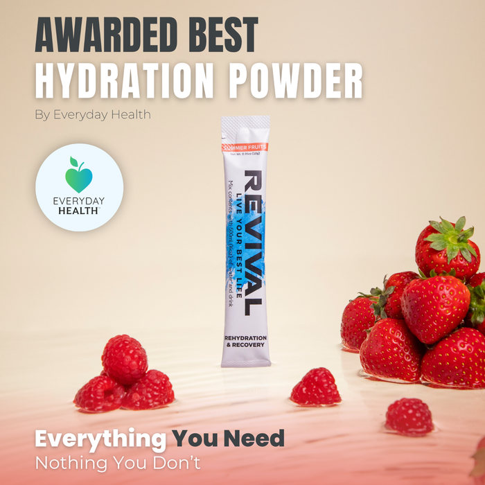 Revival Rehydration & Recovery Electrolyte Drink Summer Fruits sachet on beige background with strawberries and raspberries.