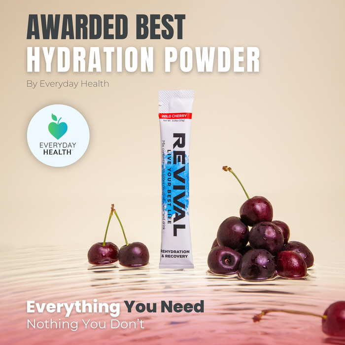 Revival Wild Cherry Rehydration & Recovery electrolyte sachet on beige background with fresh cherries and Everyday Health award logo.