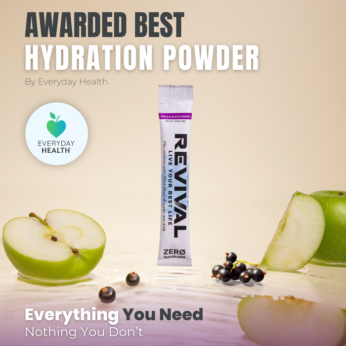 Revival ZERO Apple Blackcurrant electrolyte sachet on beige background with green apples and blackcurrants, "Awarded Best Hydration Powder by Everyday Health"