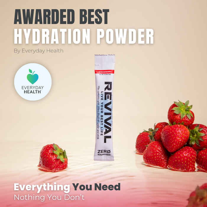 Revival Rehydration ZERO Strawberry electrolyte sachet on cream background with fresh strawberries and Everyday Health award badge.
