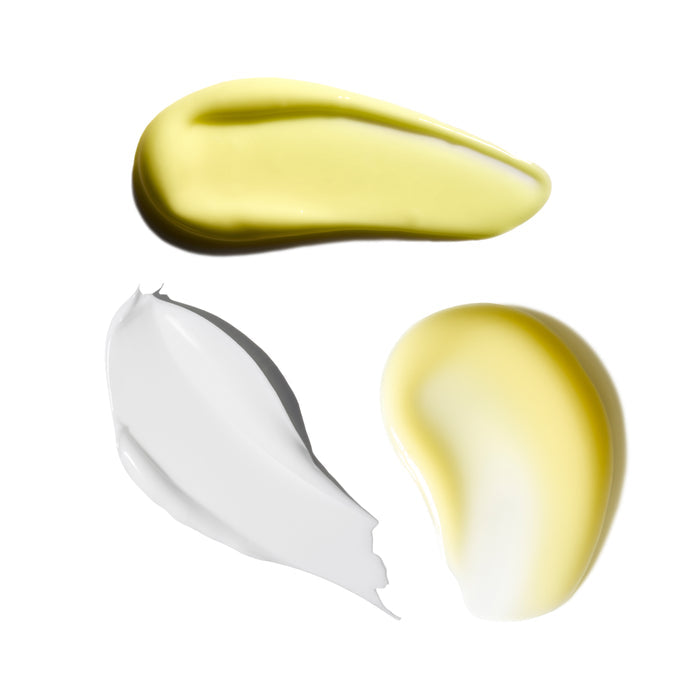 Three swatches of different colored creams on a white background