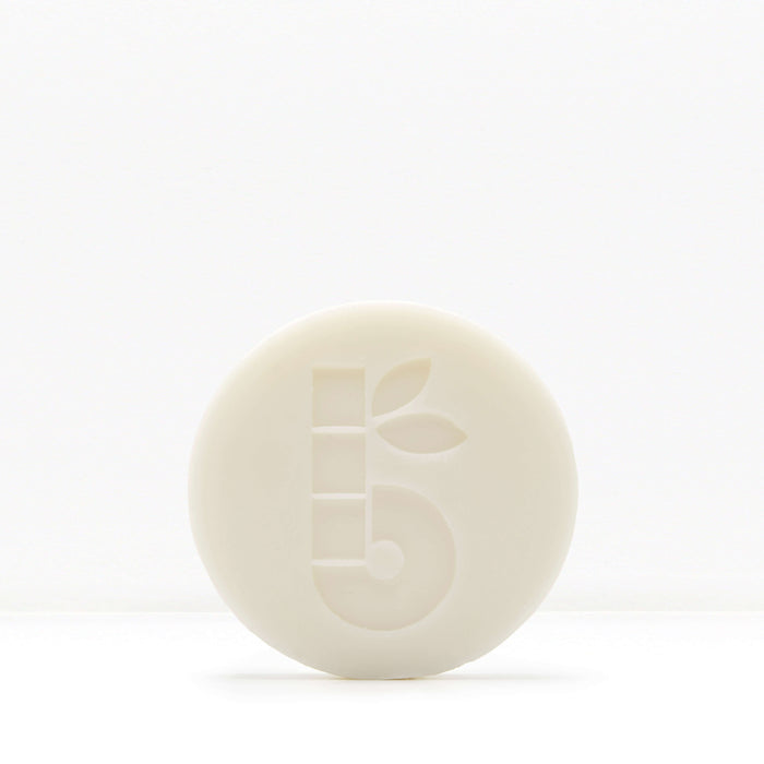 White shaving bar with a subtle embossed pattern on a pale background