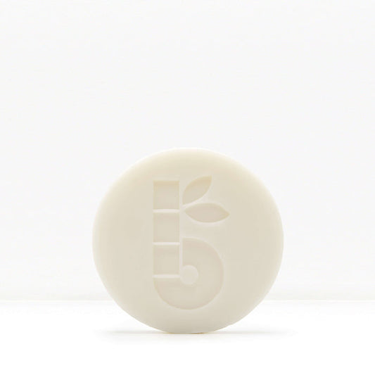White shaving bar with a subtle embossed pattern on a pale background