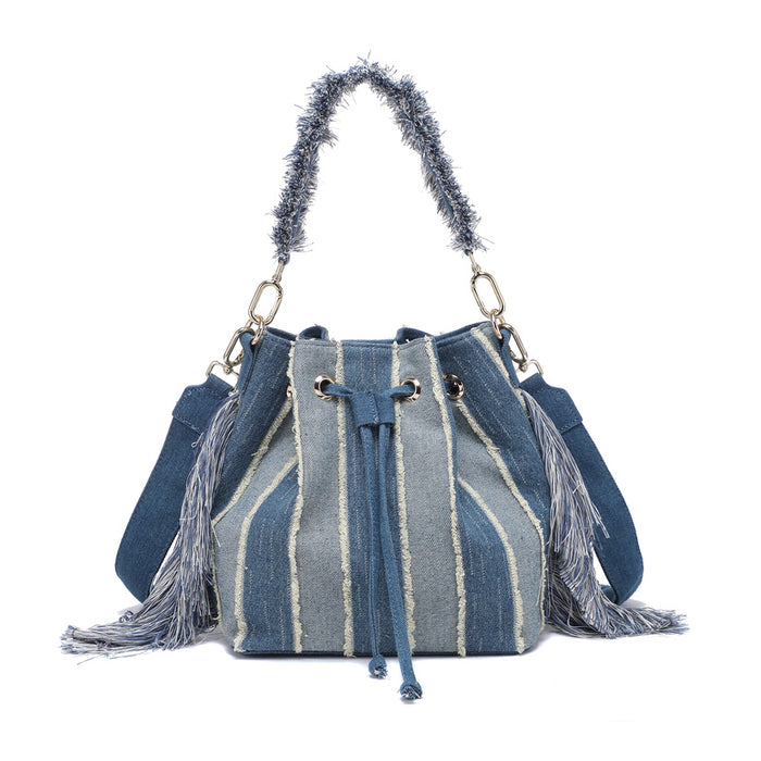 Striped denim patchwork bucket bag with fringe handle and tassel sides wholesale