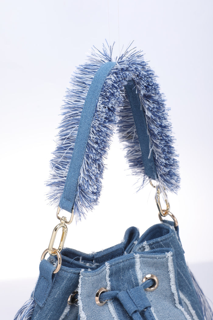 Striped denim patchwork bucket bag with fringe handle and tassel sides wholesale
