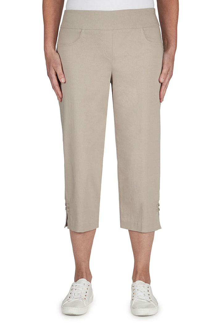 Beige capri pants worn by a person on a white background