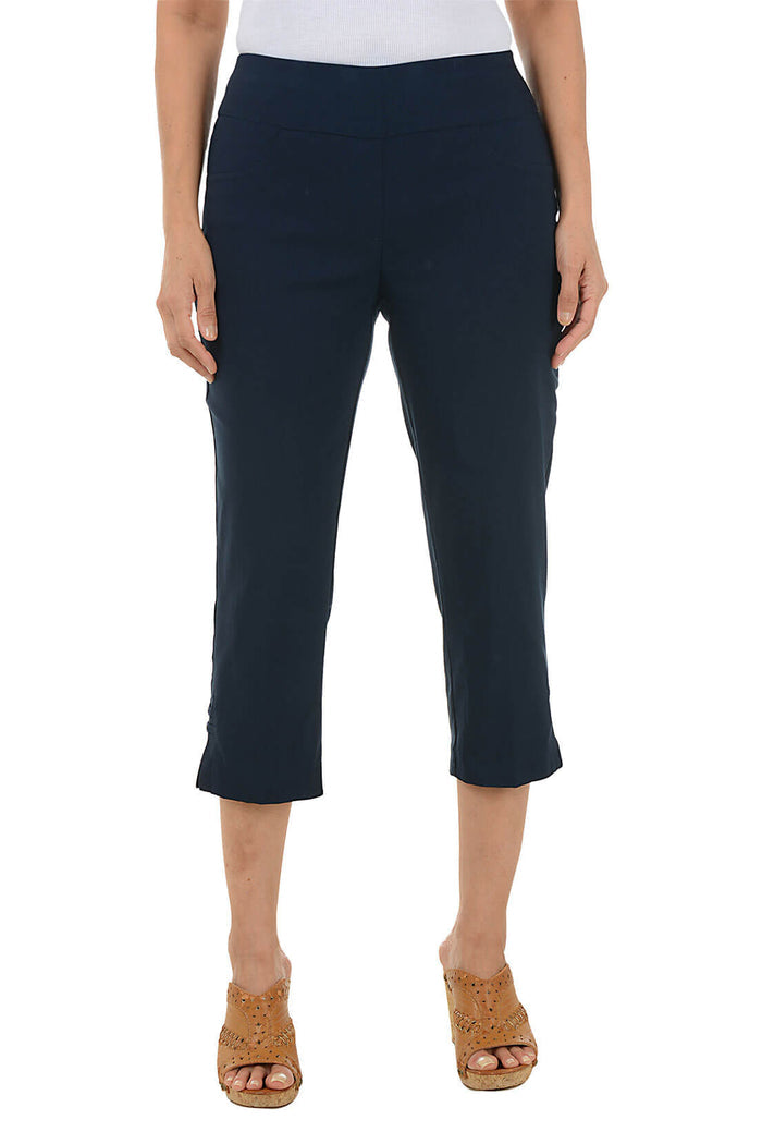 Navy blue capri pants worn by a person on a white background