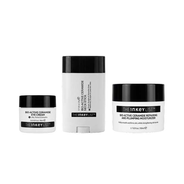 Three skincare products from The Inkey List on a plain white background: a small eye cream jar, a tall cream stick, and a moisturizer jar. The containers are white with black lids and black label bands.