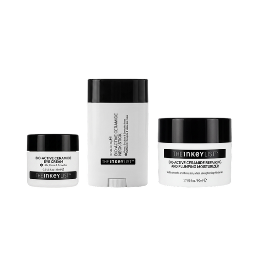 Three skincare products from The Inkey List on a plain white background: a small eye cream jar, a tall cream stick, and a moisturizer jar. The containers are white with black lids and black label bands.