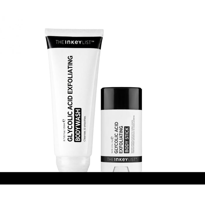 The Inkey List Glycolic Acid Exfoliating Body Wash tube standing next to a matching Glycolic Acid Exfoliating Body Stick on a white background with a black reflective base.