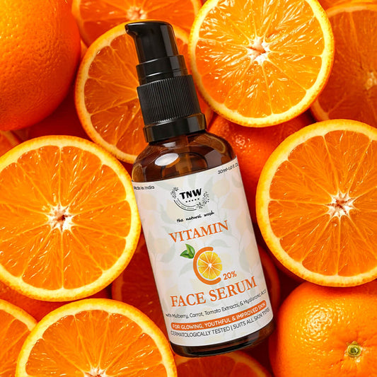 Bottle of TNW Vitamin C Face Serum surrounded by sliced oranges