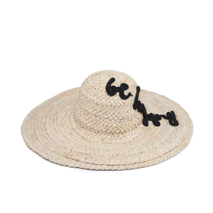 Wide brim raffia hat with “be happy” text detail wholesale