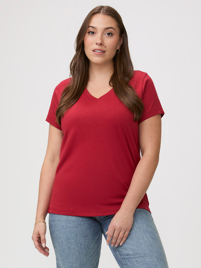 Laurel is 5'7" and wears a size M # Woman wearing a chili red t-shirt and blue jeans | great v-neck tees for everyday